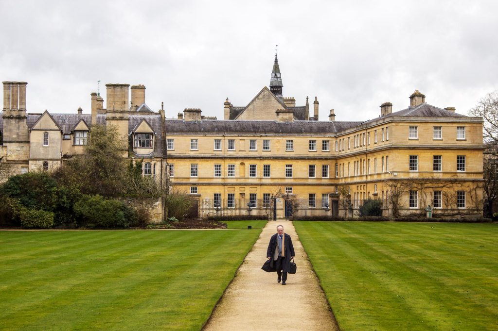 historic oxford college building with garden path